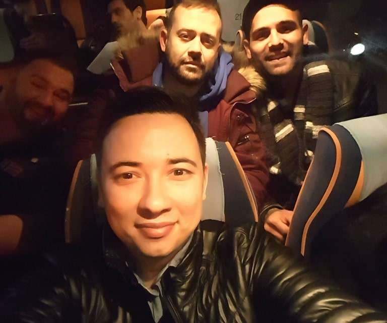 Eugene Charalampous with fellow contestants on a coach at night