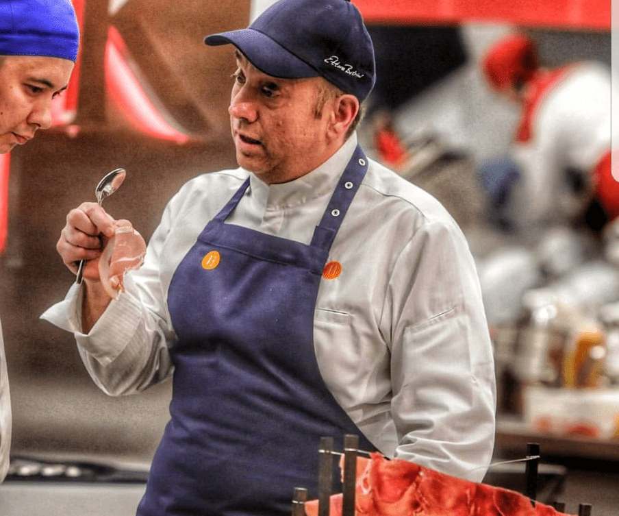 A chef tasting from a spoon on the Hell’s Kitchen Greece set