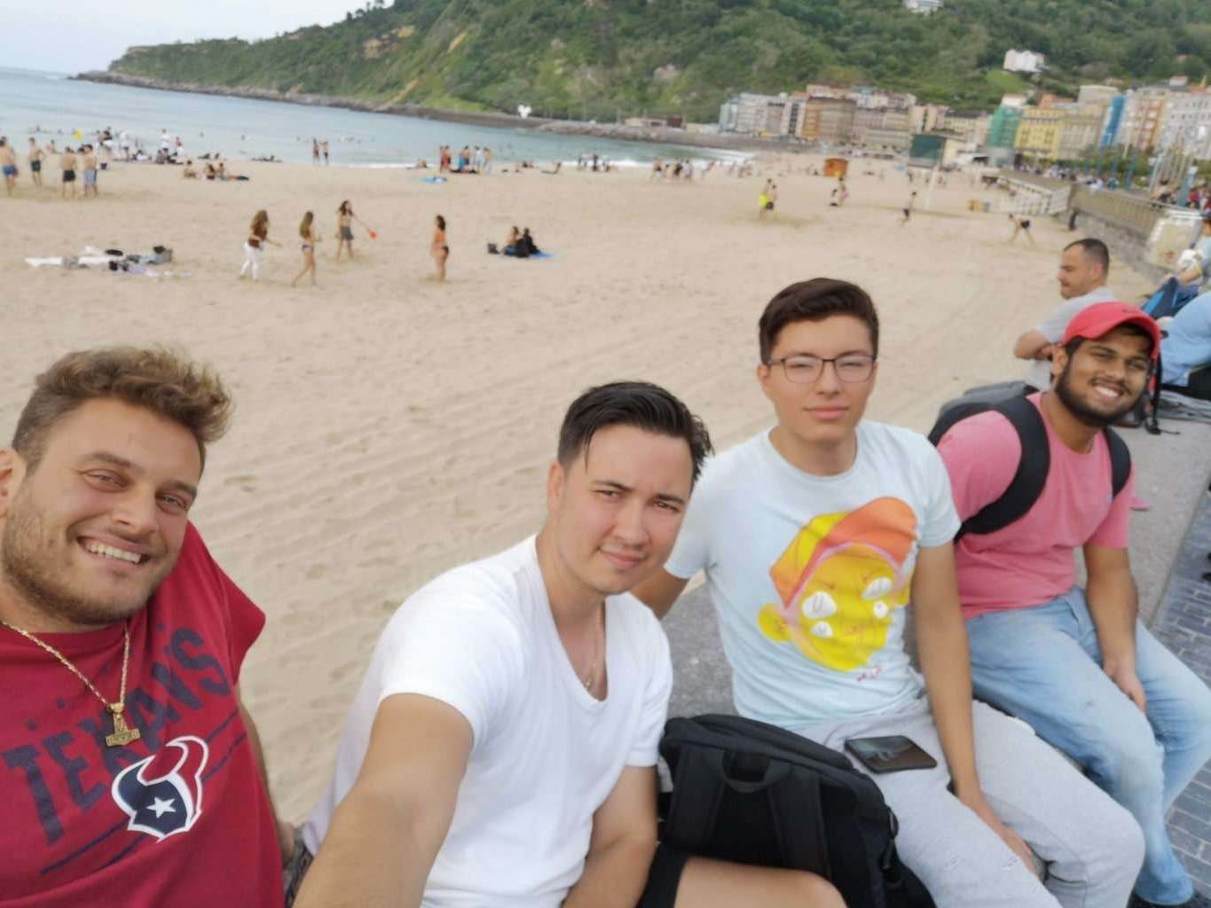 Eugene Charalampous with a group of young men on the beach in San Sebastián